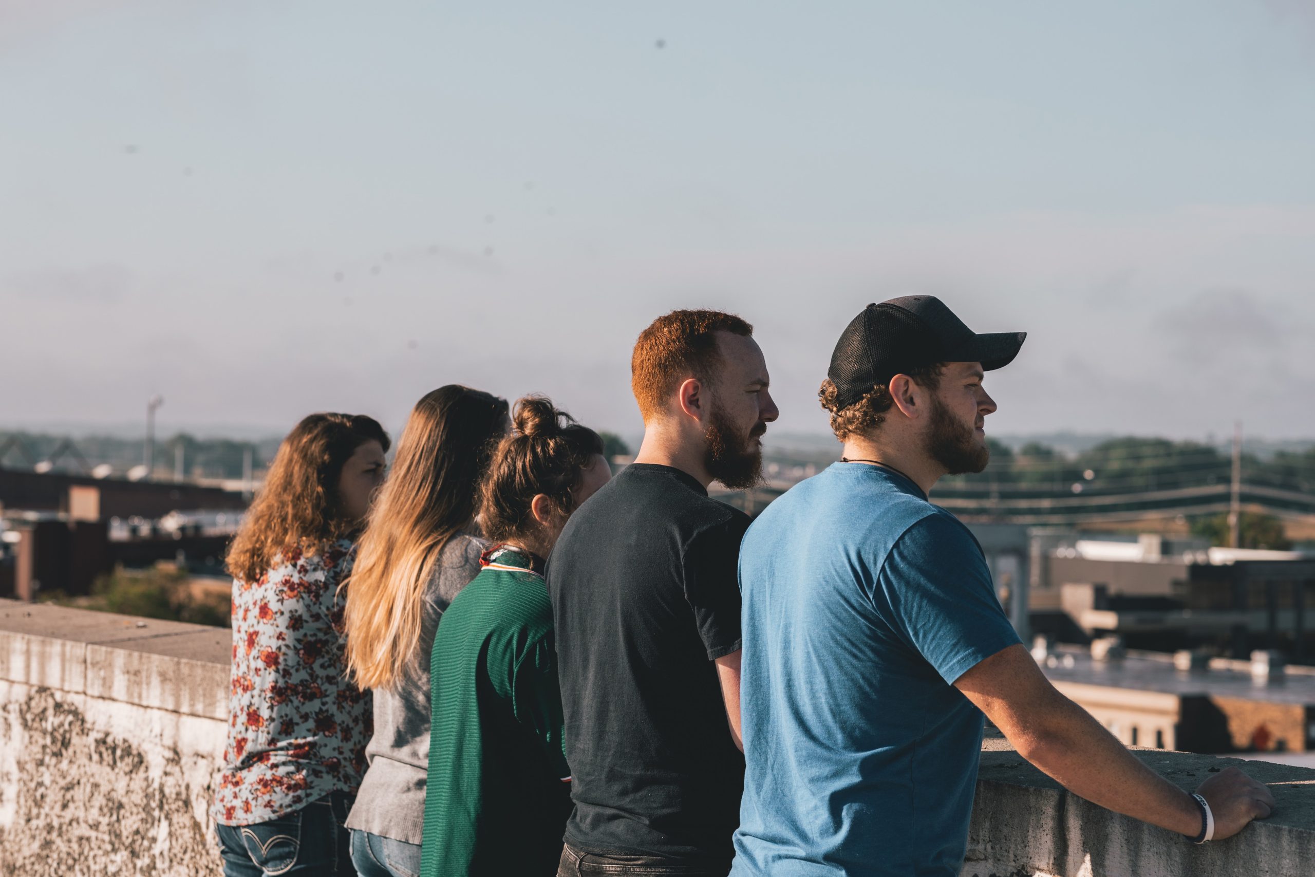 Group of young people stood in a line looking out to the distance