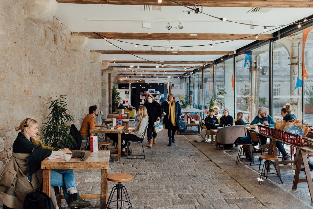 Wide angled photo of people eating and drinking in a cafe